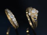 a close up of two gold rings with diamonds on them