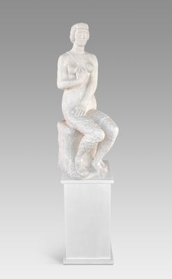 a white marble statue of a woman sitting on a rock