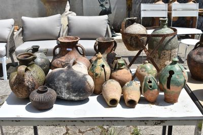 many vases on a table outside on the patio