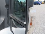 a side view mirror of a truck that is parked in a lot