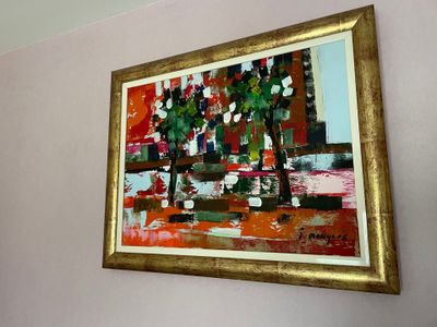 a picture of a painting hanging on the wall above a bed