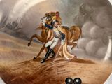 a plate with a painting of a man riding a horse
