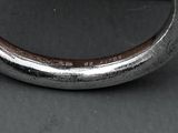 a close up of a metal object on a black surface