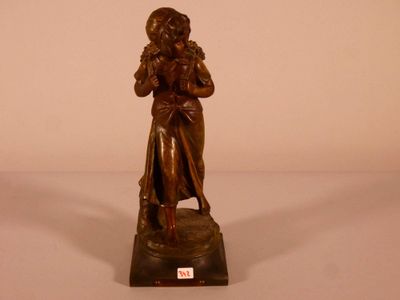 bronze statue of a woman holding a child on a marble base