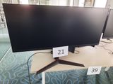 two monitors sitting on a table with price tags on them