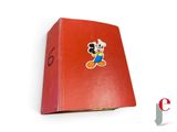 mickey mouse sticker on the back of a red book