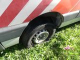 a red and white van that is parked in the grass