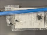 a blue toothbrush sitting on top of a piece of plastic