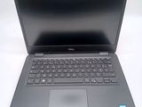 the dell laptop is open and ready to be used