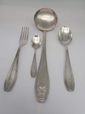 a spoon, fork, and spoon rest on a table