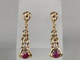 a pair of ruby and diamond earrings