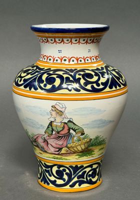 a vase with a painting on it sitting on a table