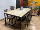 tables and chairs in a room with a chalkboard on the wall