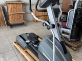 a stationary exercise bike in a garage with a pallet