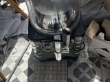 a silver food warmer sitting on the floor next to a table
