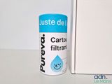 a canister of water next to a box on a table