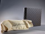 louis vuitton book and bag on a grey background