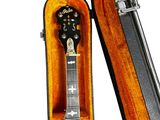 a guitar in a case that is open on a white background
