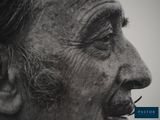 black and white photograph of an old man with a cigarette in his mouth