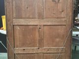 a wooden cabinet with a chain hanging from it ' s side