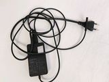 a picture of a black charger plugged into a laptop