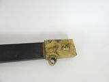 a black and gold knife on a white surface