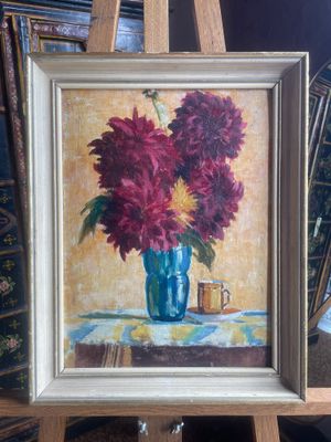 a painting of flowers in a blue vase on a easel