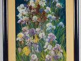 painting of a bunch of flowers in a black frame on a wall