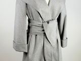 grey coat on a mannequin stand on a white background