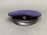 blue cap with red trim on a metal base on a table