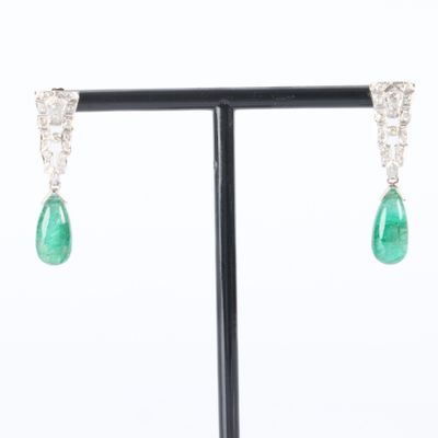 a pair of emerald and diamond earrings