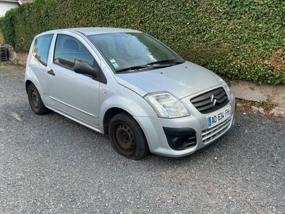a small silver car parked on the side of the road