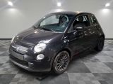 la photo d'une petite voiture noire garée dans un garage