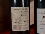 two bottles of wine sitting next to each other on a table