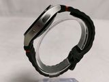 a close up of a watch on a clear stand