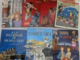 plusieurs livres pour enfants sont alignés sur une surface blanche