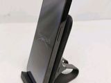a cell phone that is on a stand on a table