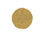 an old gold coin with a cross on it on a white surface
