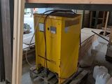 a yellow machine sitting on a pallet in a warehouse