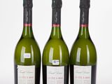 three bottles of wine sitting next to each other on a white surface