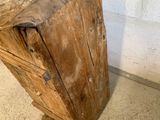a very old wooden table with a very thick piece of wood on it