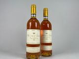two bottles of wine sitting next to each other on a table