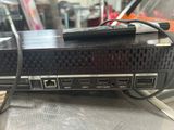 an image of a close up of a computer with a remote on top of it