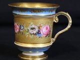 a close up of a cup on a black surface with a black background