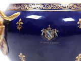 a large blue vase with gold decoration on it