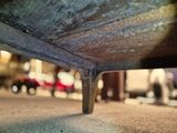 a close up picture of a metal bench on the street