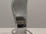 a silver lamp that is on a white table