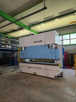 the large machine is sitting in a warehouse with a lot of windows