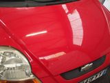 a red car that is parked in a garage