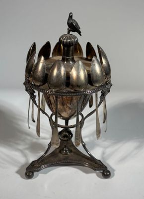 a silver bowl with spoons and spoon spoons on it